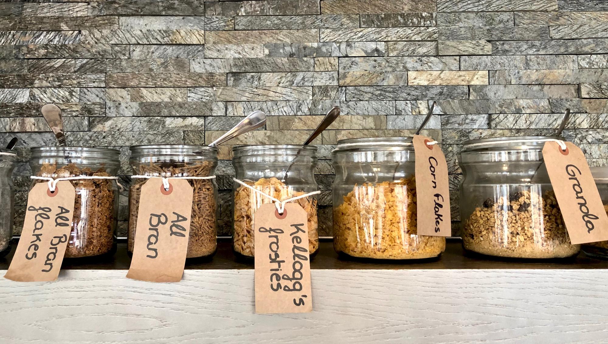 Workshop table with arranged jars and labeled ingredients